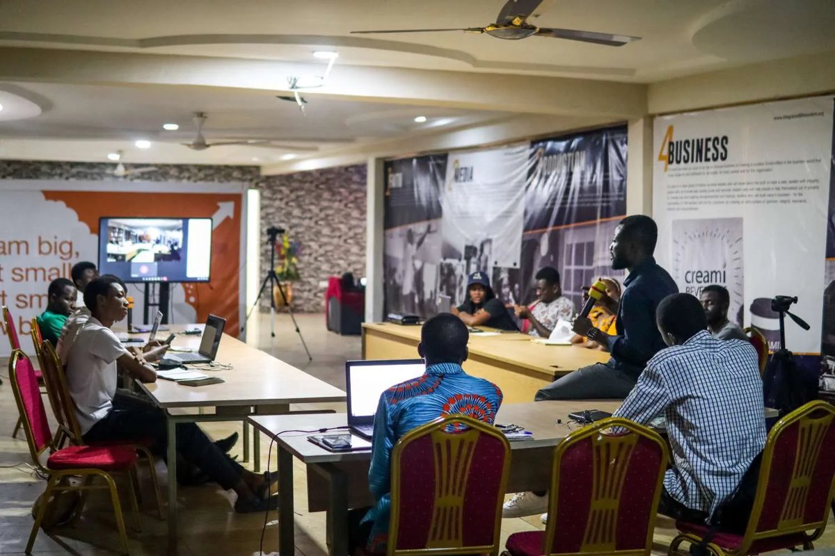 A team working at laptops around a conference table