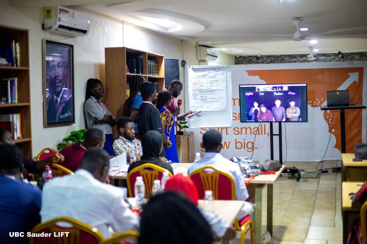 A full room watching a presentation
